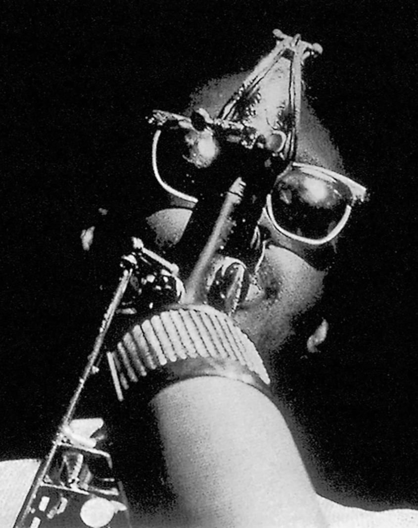 Near-abstract black & white photograph of Hank Mobley wearing sunglasses and playing tenor saxophone